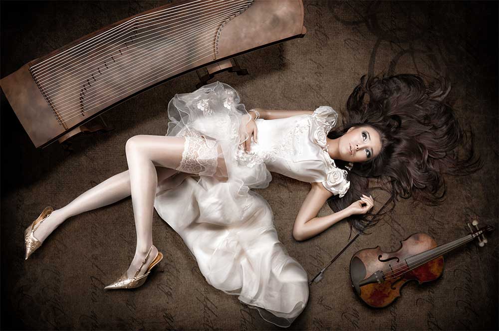 Modefotografie Asiatin im Brautkleid leigt auf dem Boden